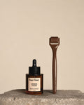 Two 'bur bur' hair care products on a stone surface with a beige background