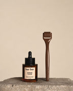 Two 'bur bur' hair care products on a stone surface with a beige background